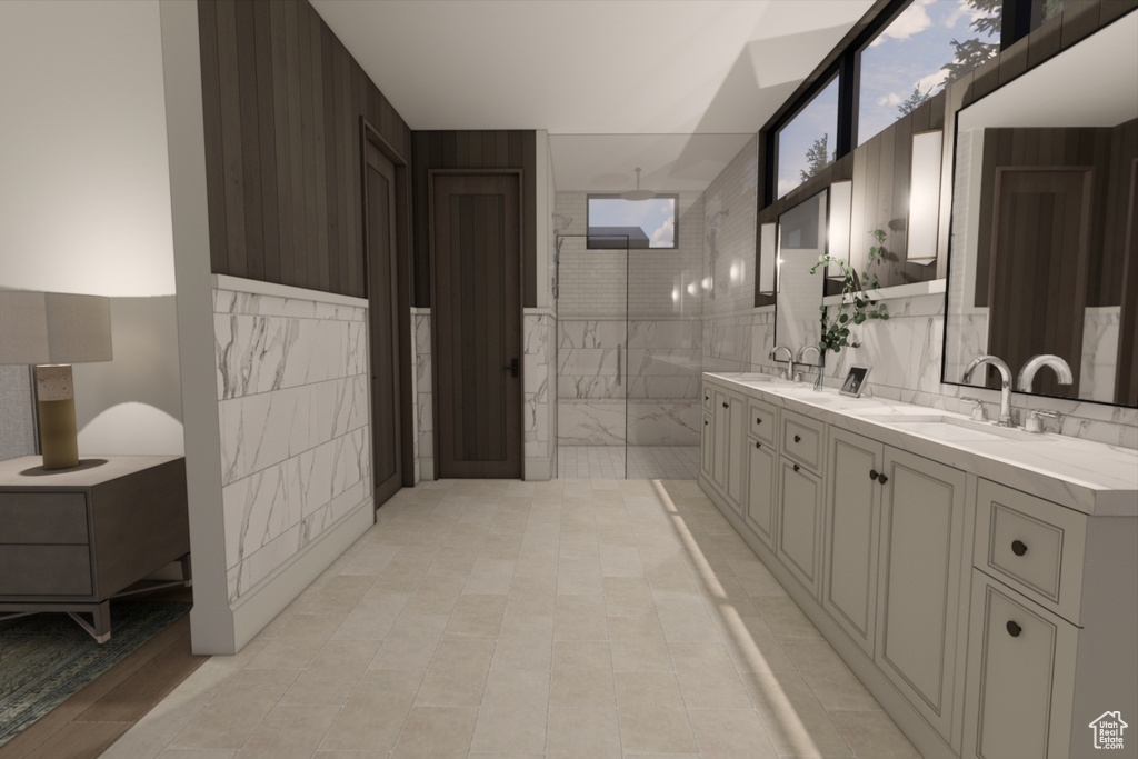 Bathroom with tile walls, dual vanity, tile patterned floors, and backsplash