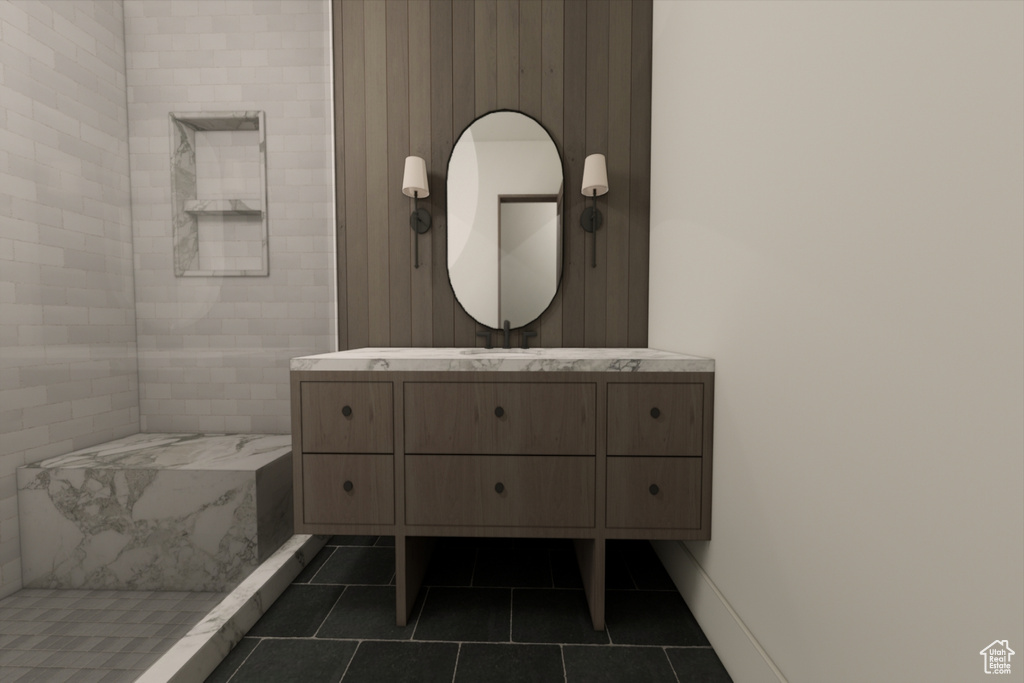 Bathroom with vanity, a tile shower, and tile patterned flooring