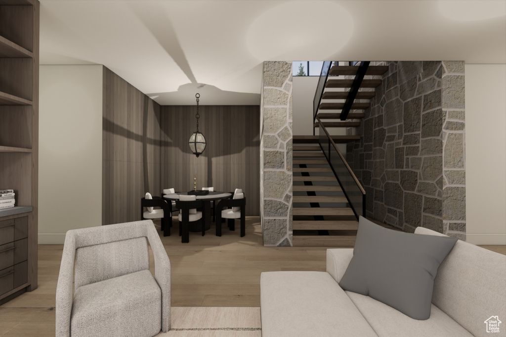 Living room featuring wooden walls and light wood-type flooring