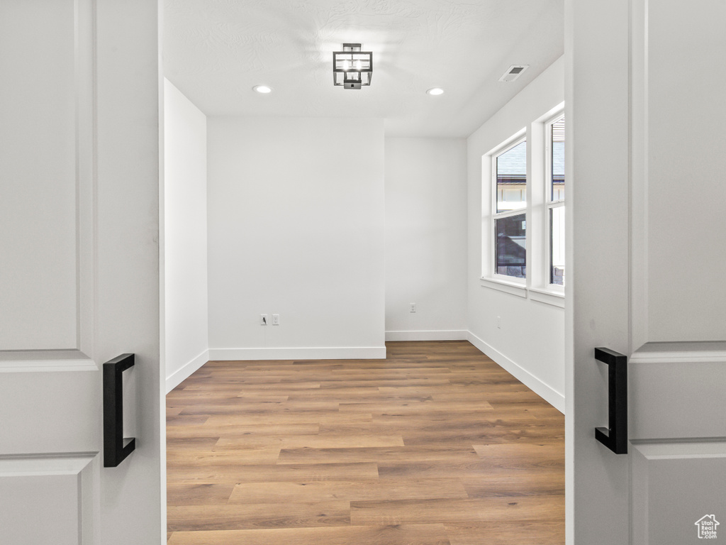 Unfurnished room featuring light wood-type flooring