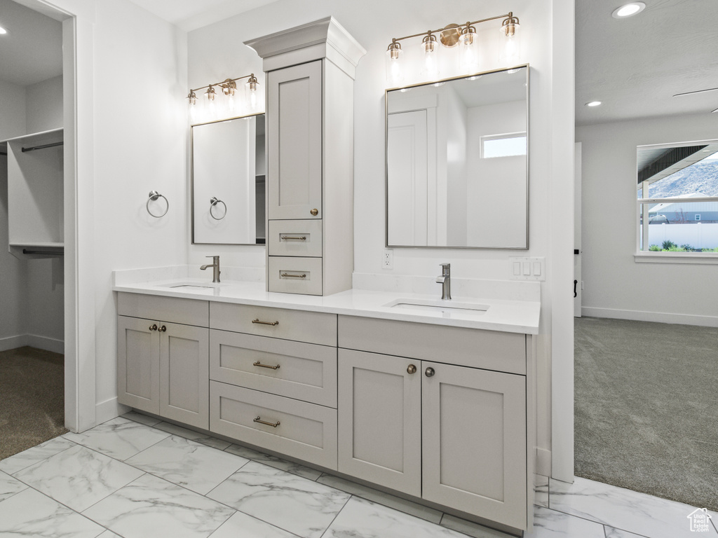 Bathroom featuring tile patterned flooring and double vanity