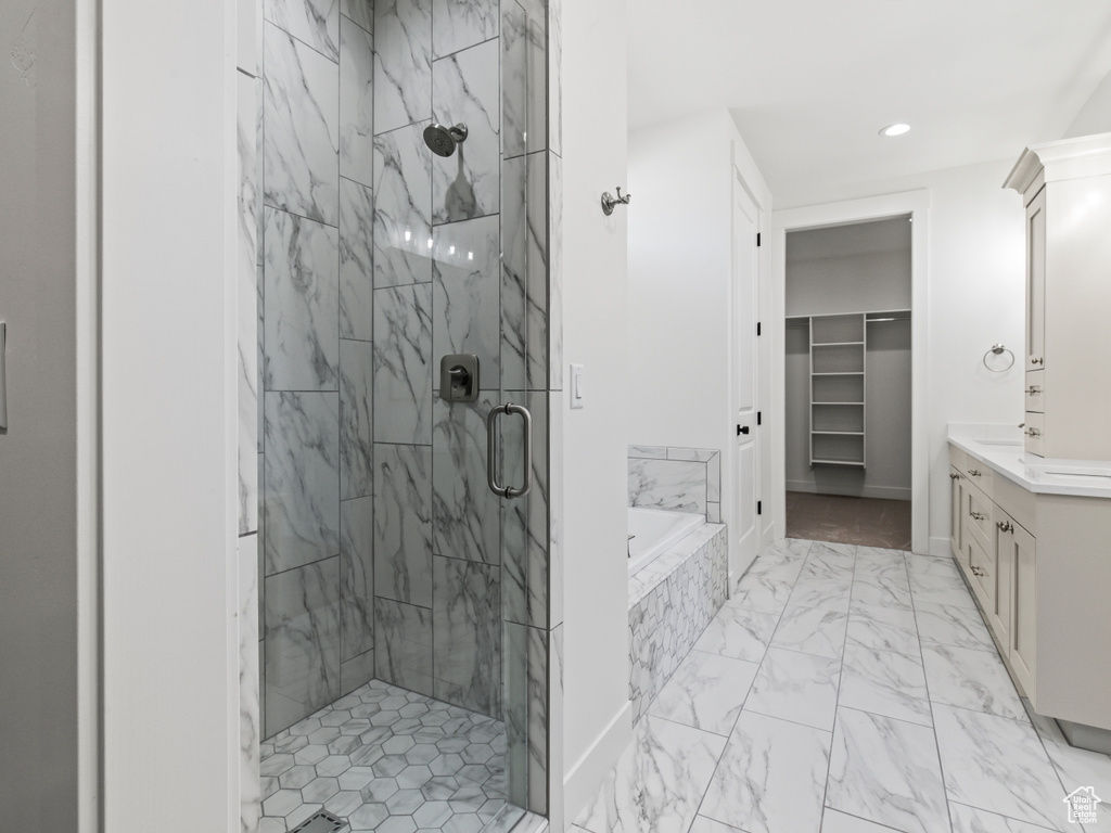 Bathroom with vanity, plus walk in shower, and tile patterned floors