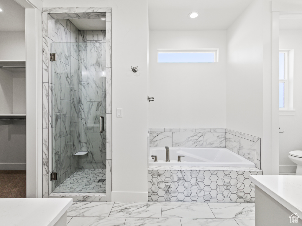 Full bathroom featuring vanity, tile patterned flooring, toilet, and separate shower and tub