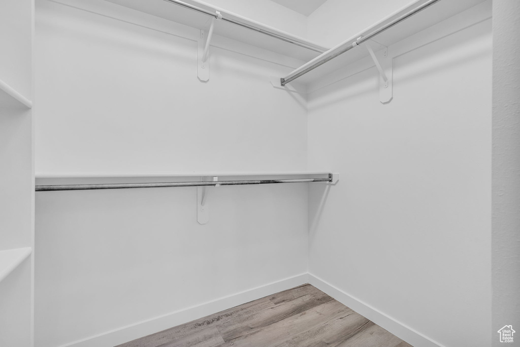 Spacious closet featuring hardwood / wood-style flooring