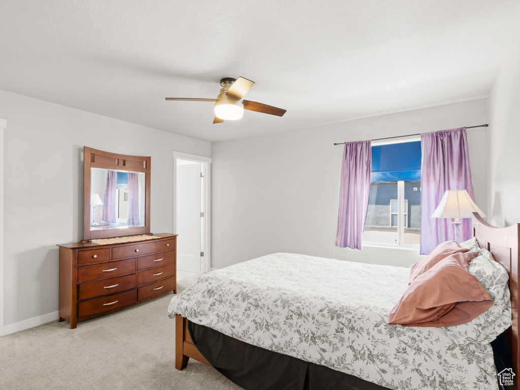 Bedroom with light carpet and ceiling fan