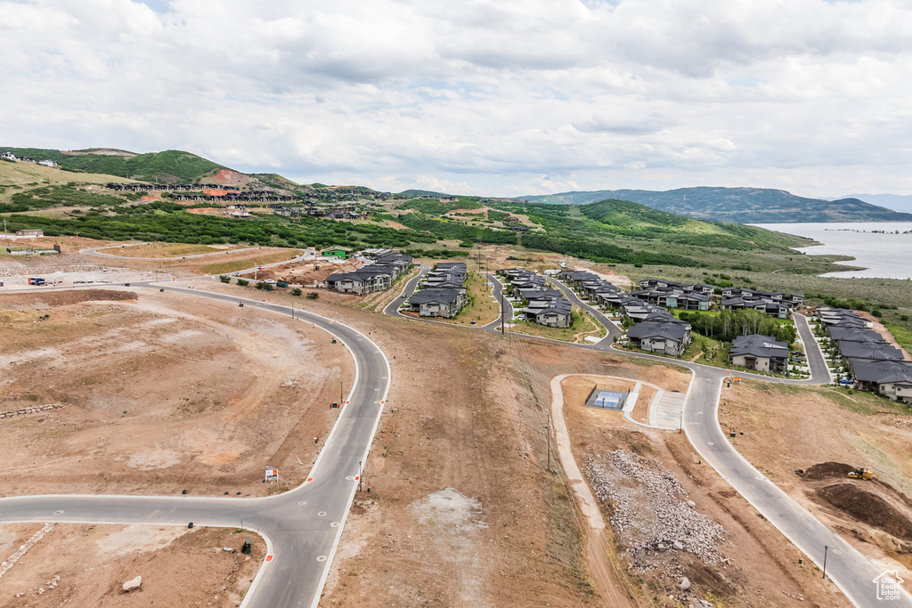 Birds eye view of property with a water and mountain view