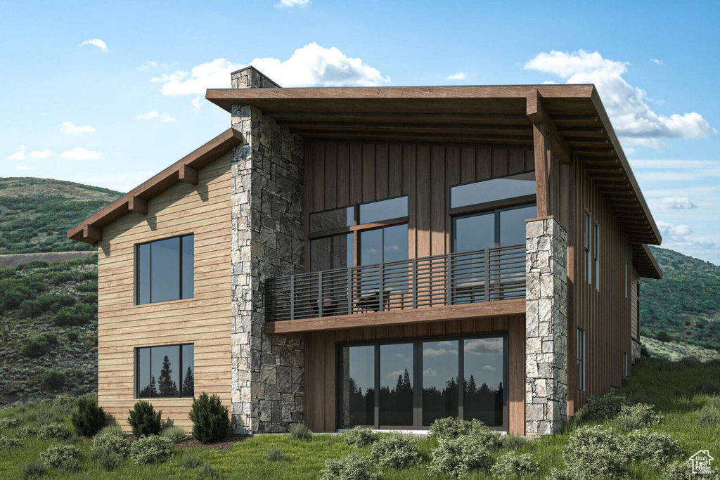 Back of house with a balcony