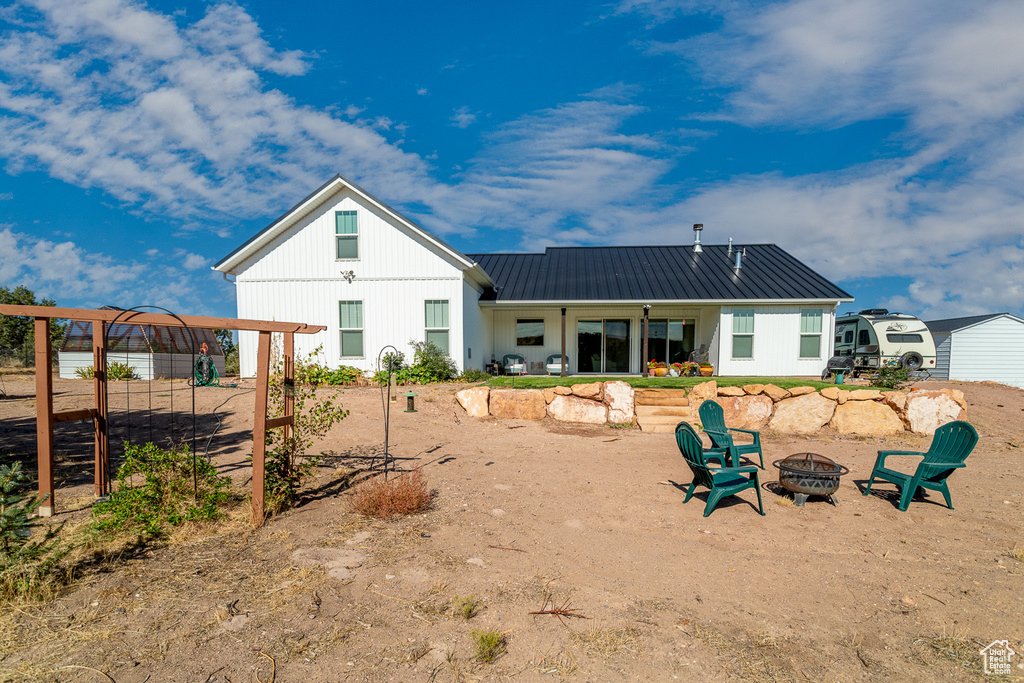 Back of house with an outdoor fire pit