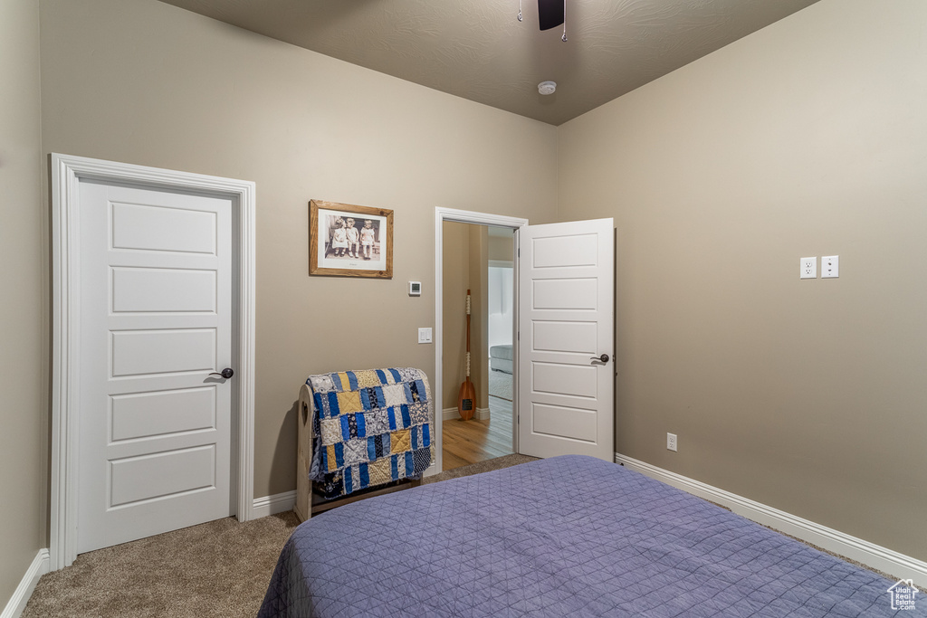 Bedroom with light carpet and ceiling fan