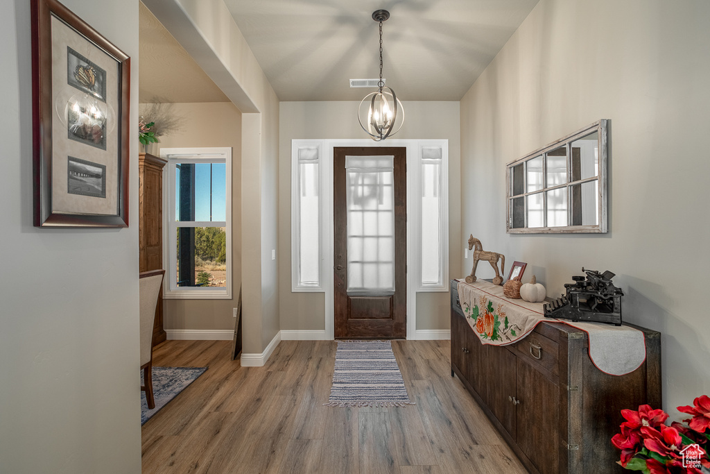 Entryway featuring a notable chandelier and light hardwood / wood-style floors