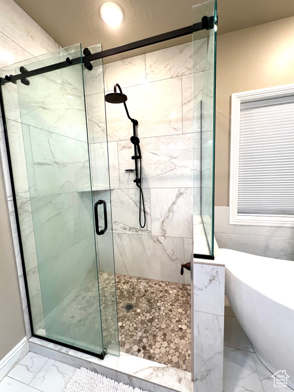 Bathroom featuring separate shower and tub