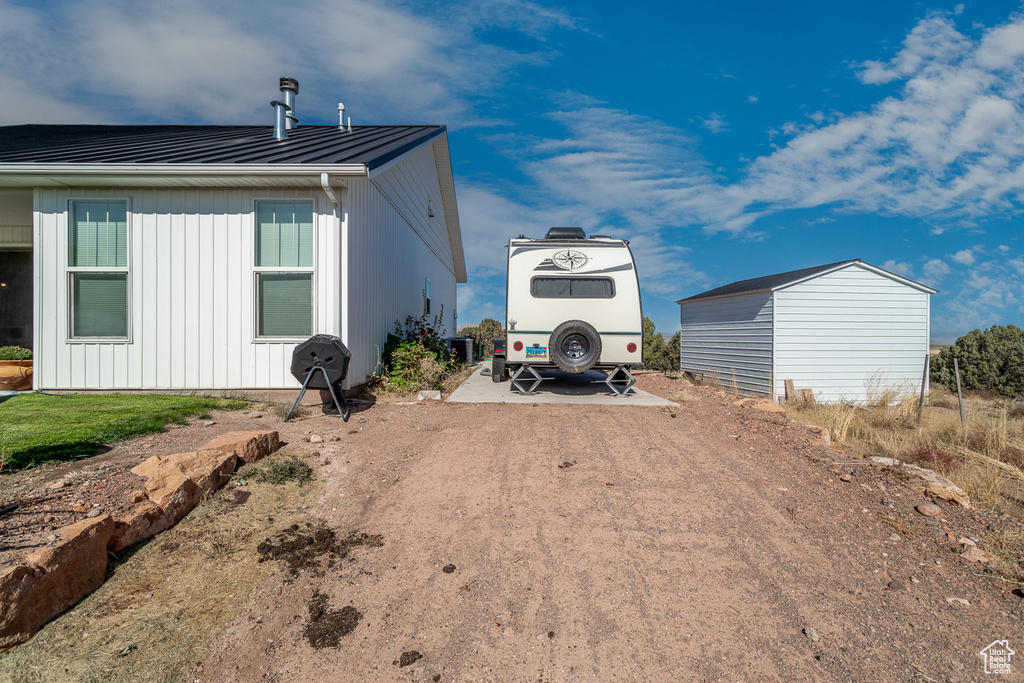 View of side of home with an outbuilding