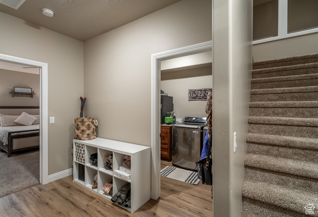 Interior space featuring light hardwood / wood-style flooring and washing machine and clothes dryer