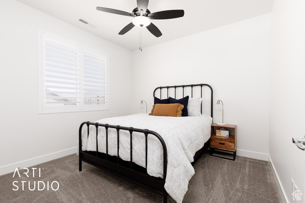 Bedroom with dark carpet and ceiling fan