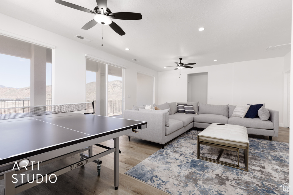 Living room featuring light hardwood / wood-style floors and ceiling fan