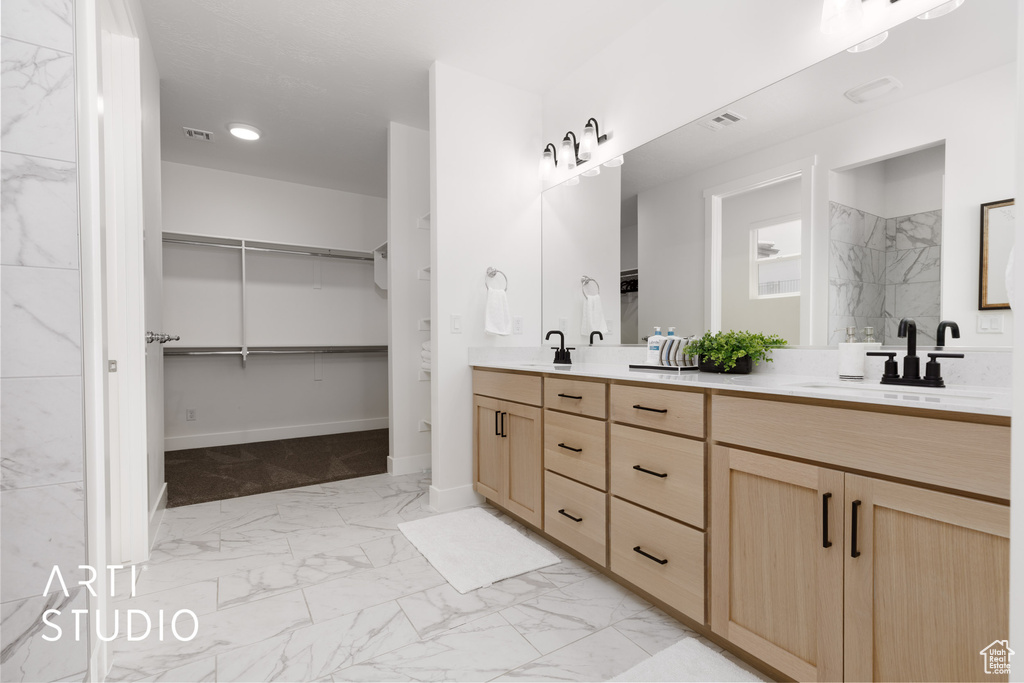 Bathroom with tile patterned flooring and double sink vanity