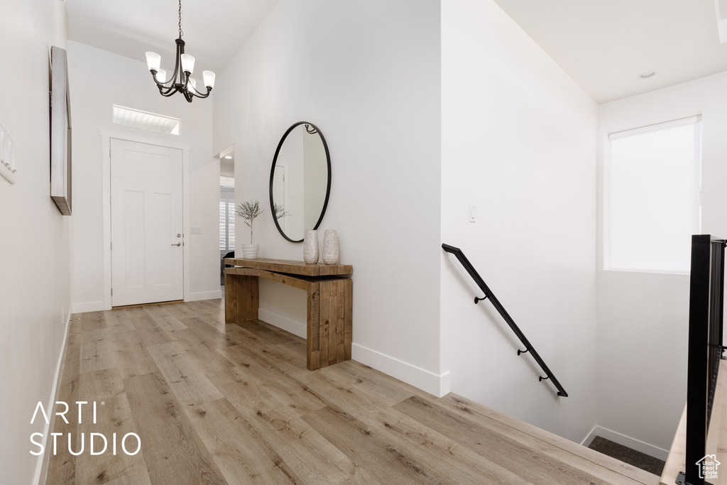 Entryway featuring light hardwood / wood-style flooring and a notable chandelier