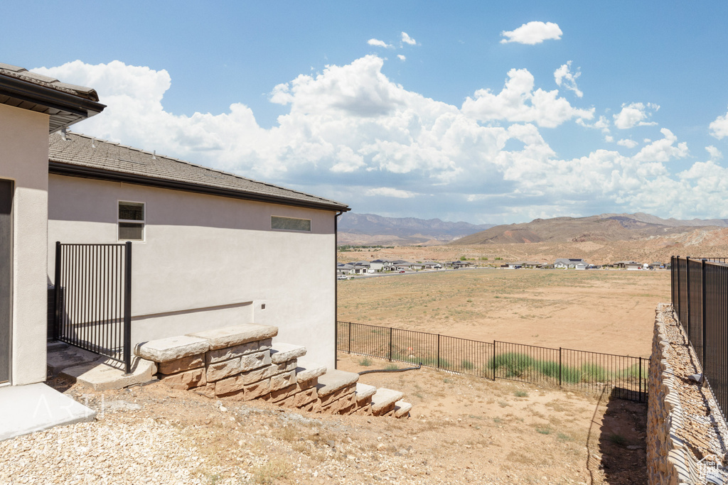 View of yard with a rural view and a mountain view