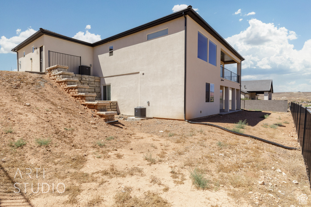 View of side of home with a balcony and central AC