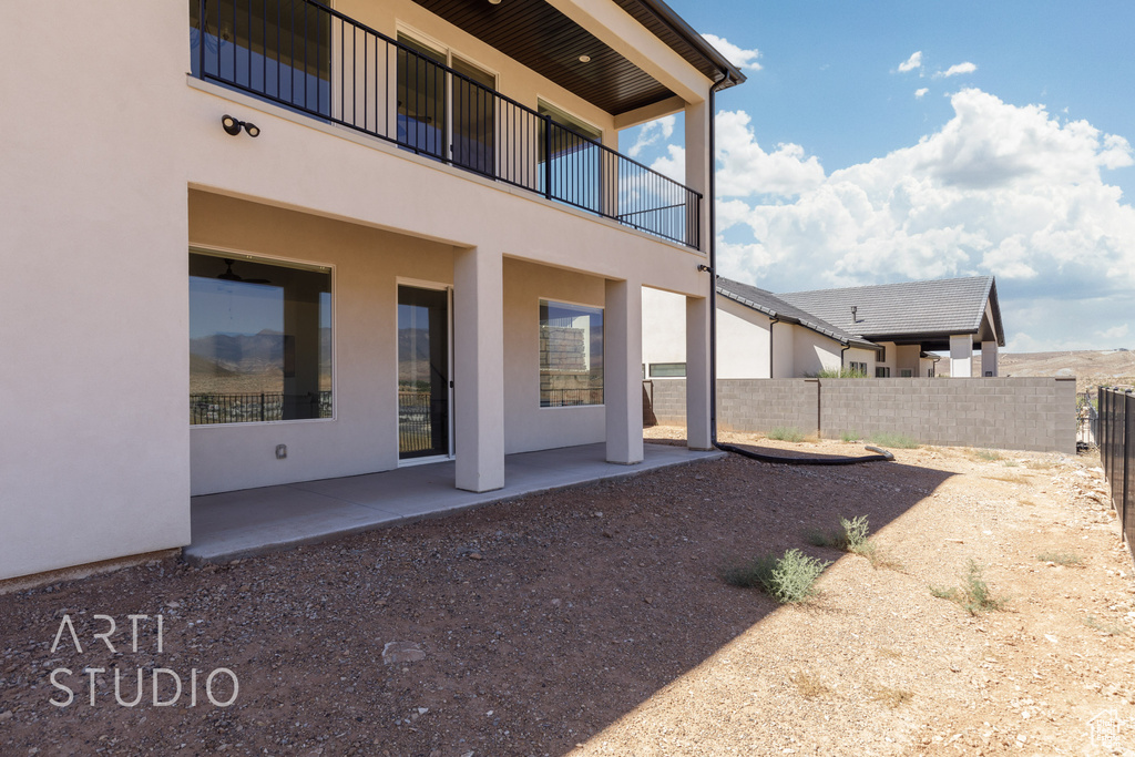 Exterior space featuring a balcony and a patio