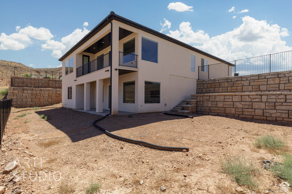 Back of property featuring a balcony