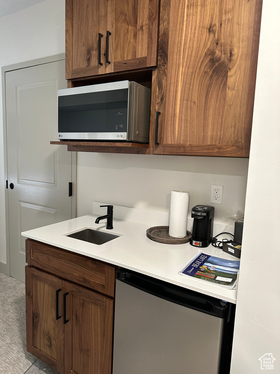 Kitchen with sink and light colored carpet