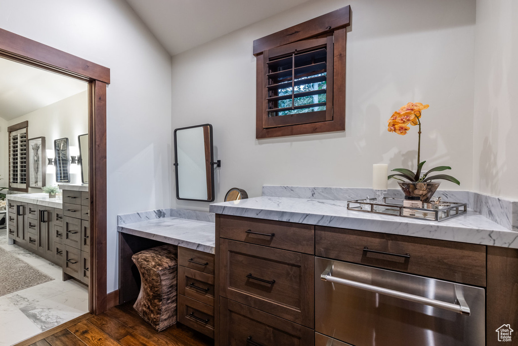 Bathroom featuring vanity, hardwood / wood-style flooring, and lofted ceiling