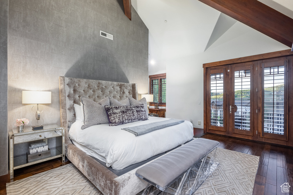 Bedroom featuring high vaulted ceiling, beamed ceiling, french doors, and wood-type flooring