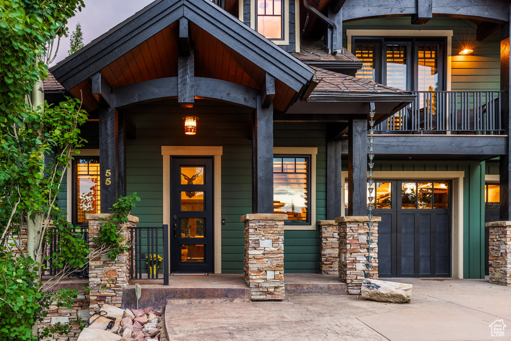 Exterior entry at dusk with a balcony