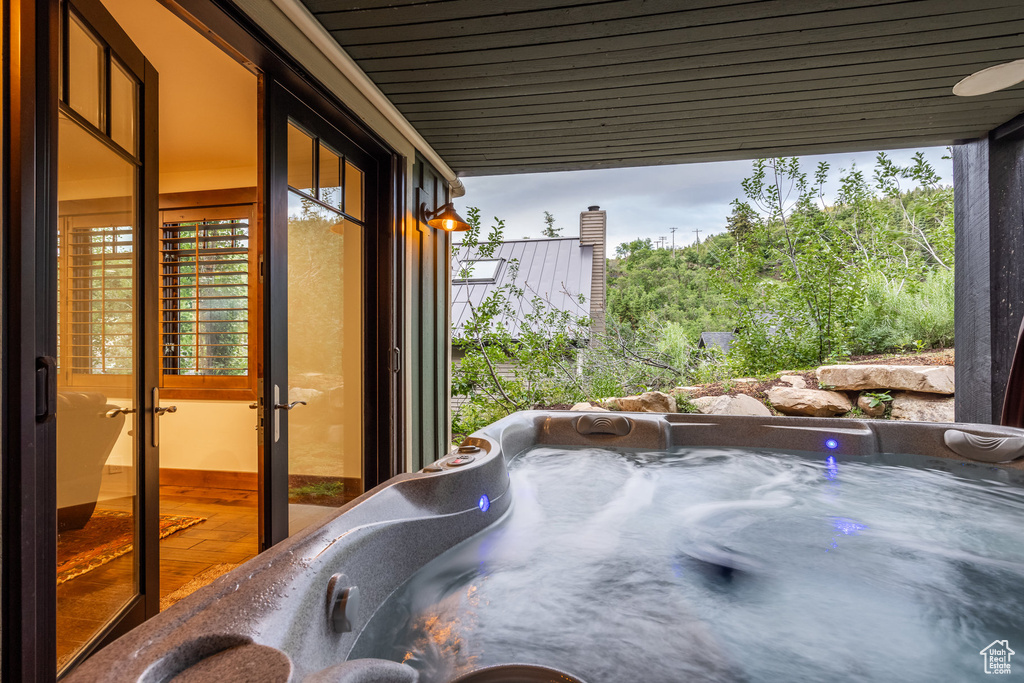 View of patio with a hot tub