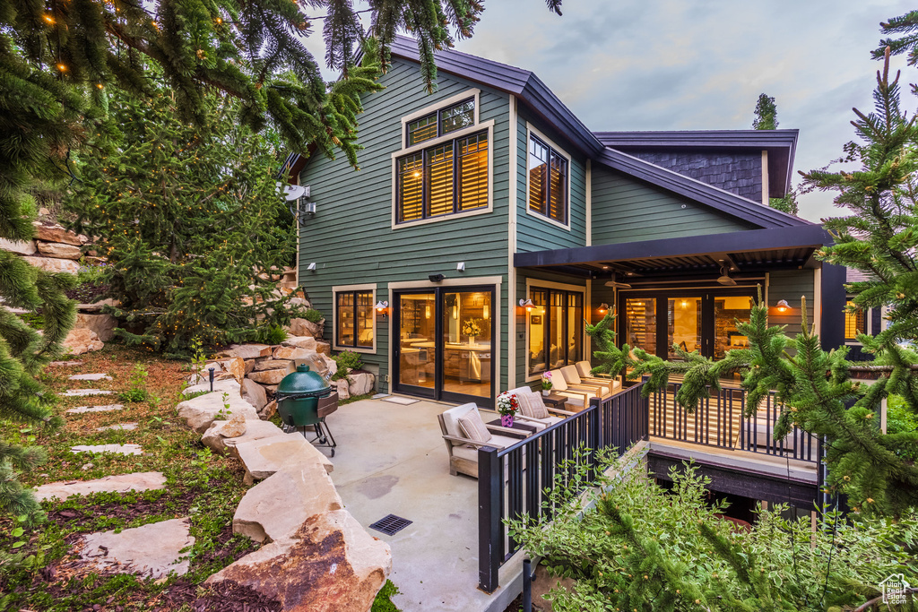 View of front of home with a patio area and outdoor lounge area