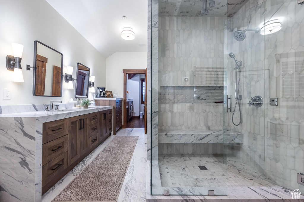 Bathroom with a shower with shower door, vanity, and hardwood / wood-style floors