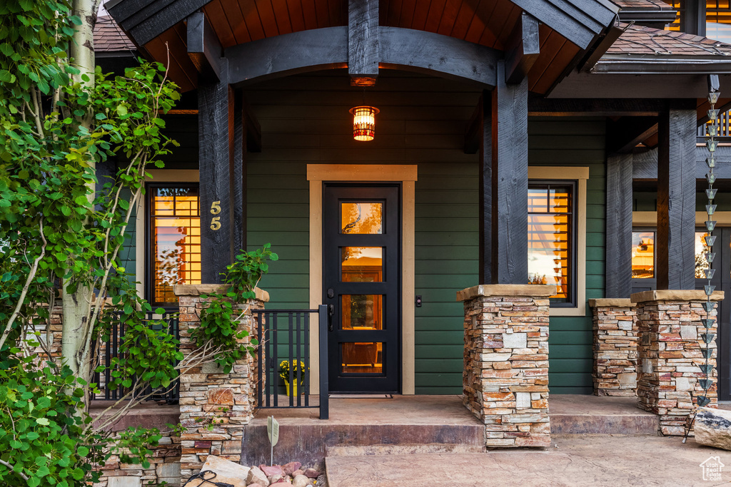 View of exterior entry with covered porch