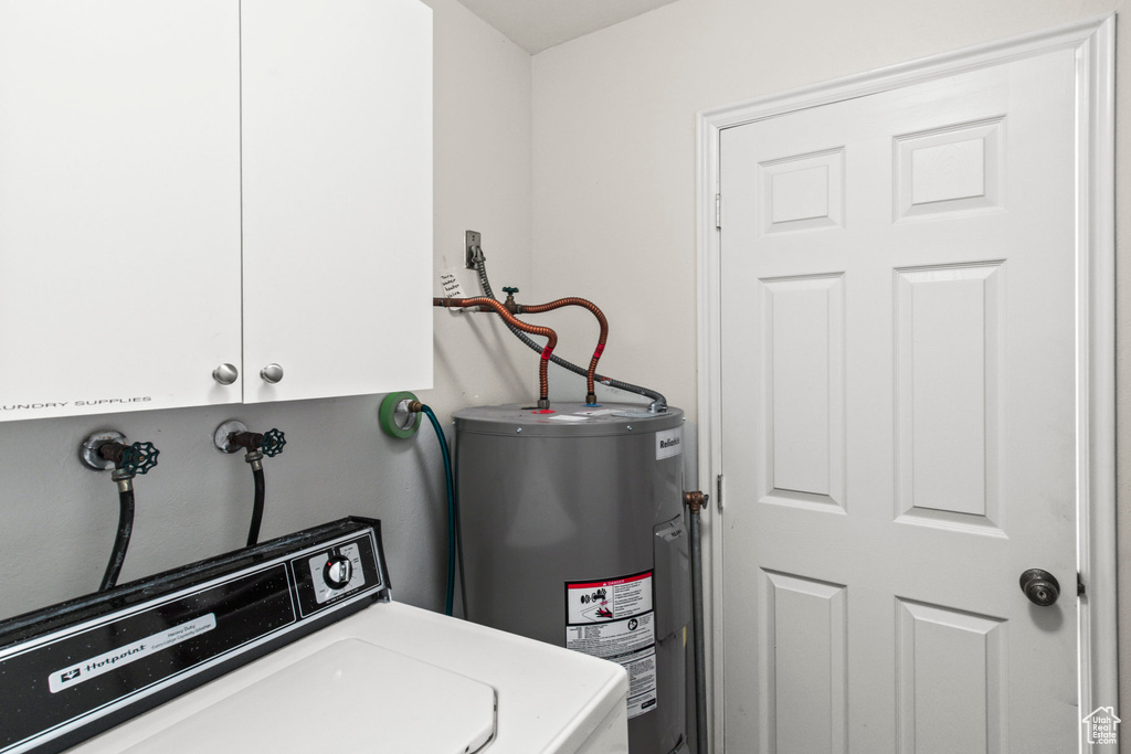 Interior space featuring water heater and washer / dryer