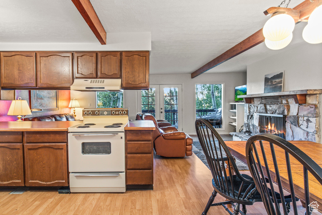 Kitchen with a stone fireplace, white electric range, light hardwood / wood-style floors, and beam ceiling