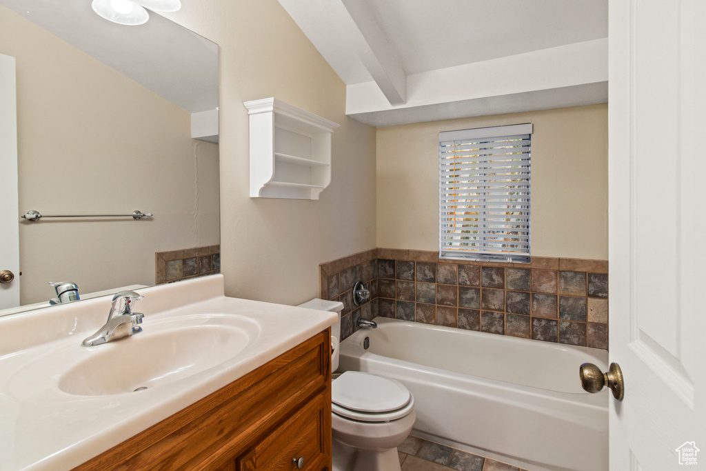 Bathroom with vanity, tile patterned flooring, toilet, and a bathtub