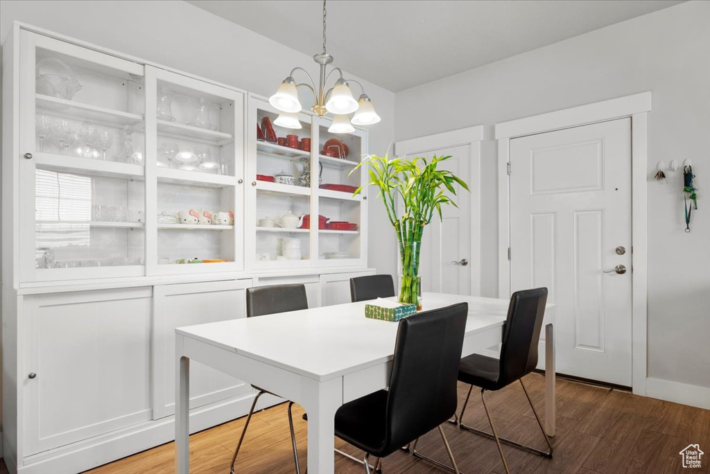 Dining space featuring wood-type flooring and a chandelier