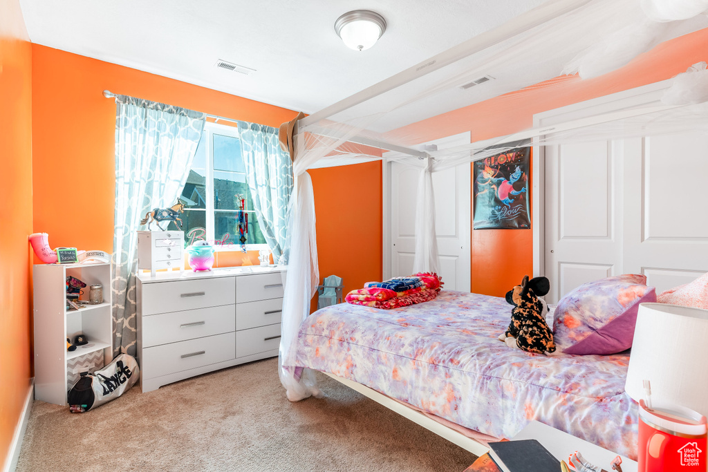 Carpeted bedroom featuring a closet