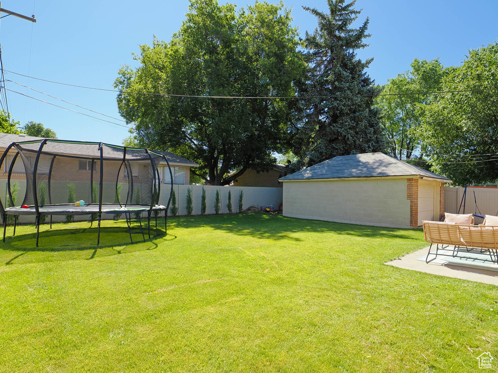 View of yard featuring a trampoline