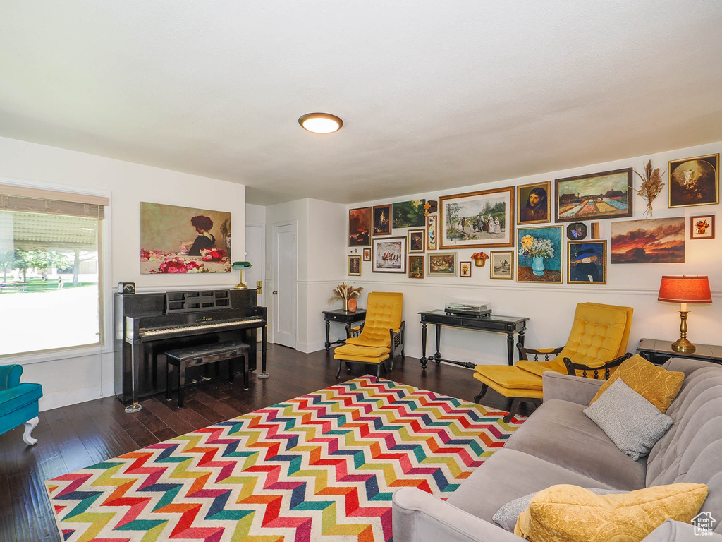 Living room with dark wood-type flooring