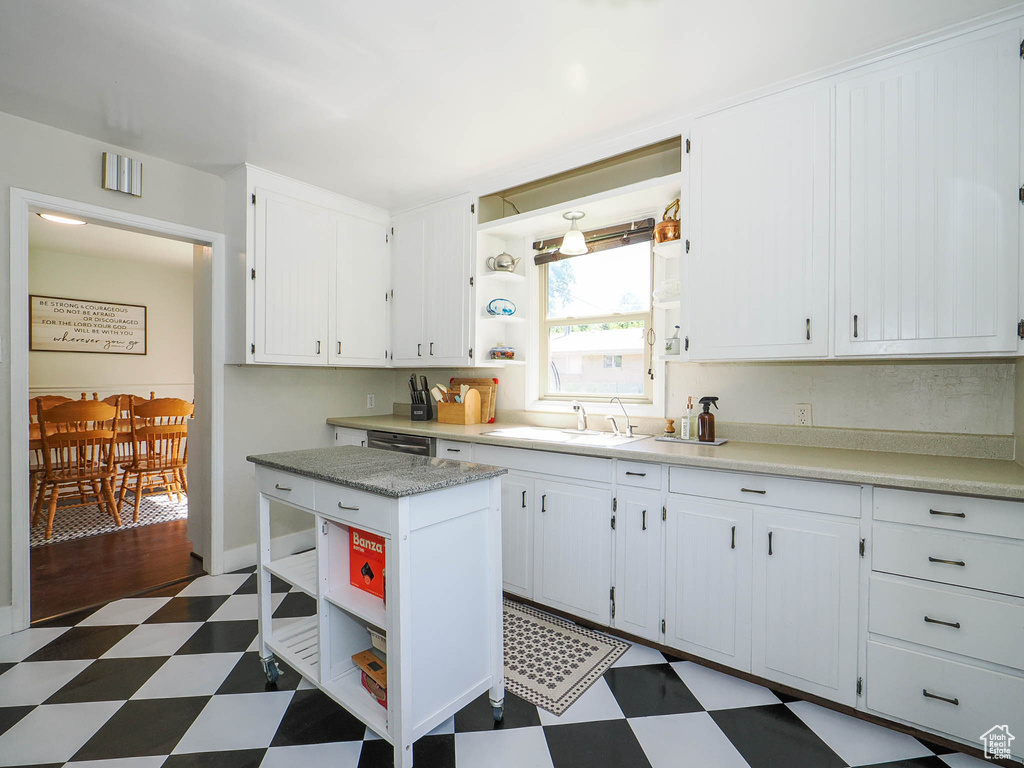 Kitchen with sink, white cabinetry, and tile patterned floors