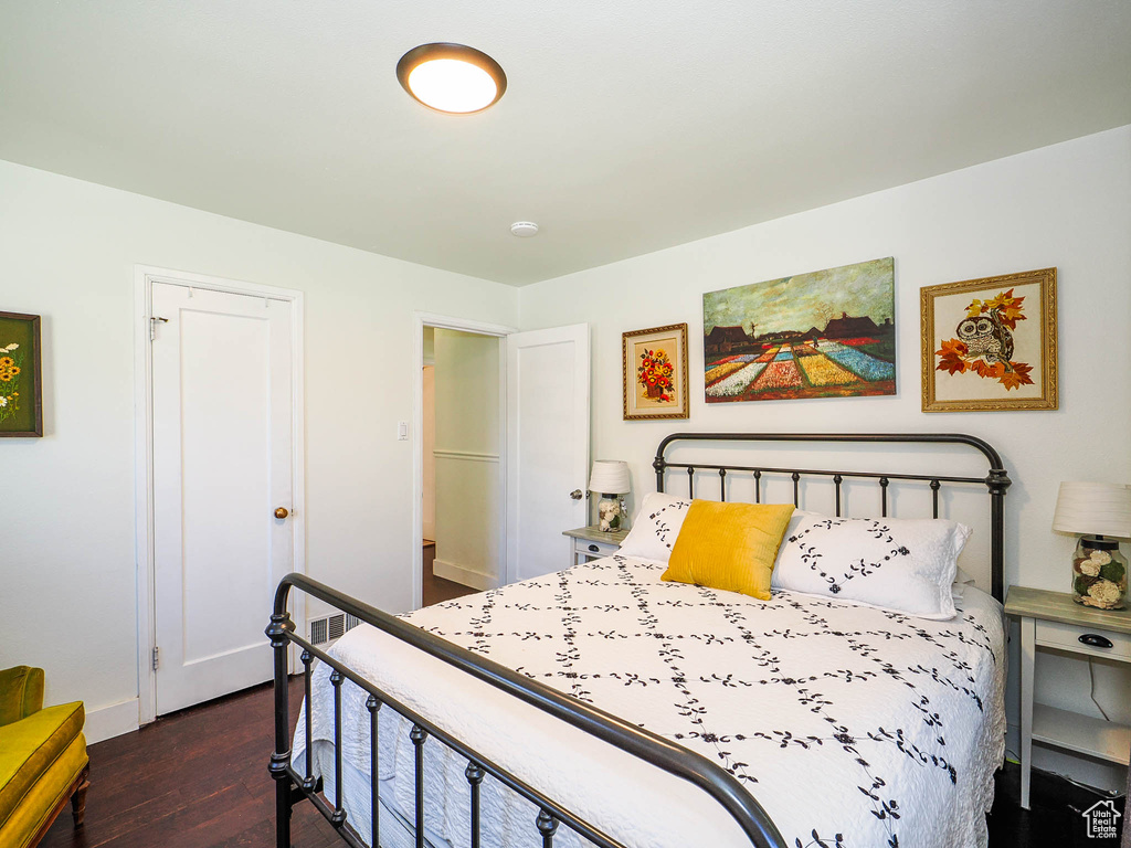 Bedroom with dark hardwood / wood-style floors