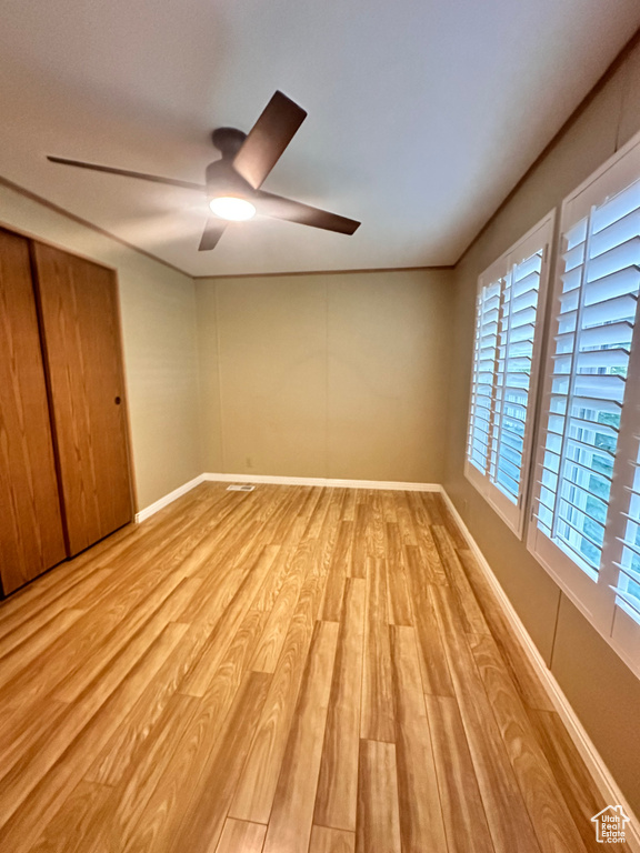 Unfurnished bedroom featuring light hardwood / wood-style flooring and ceiling fan