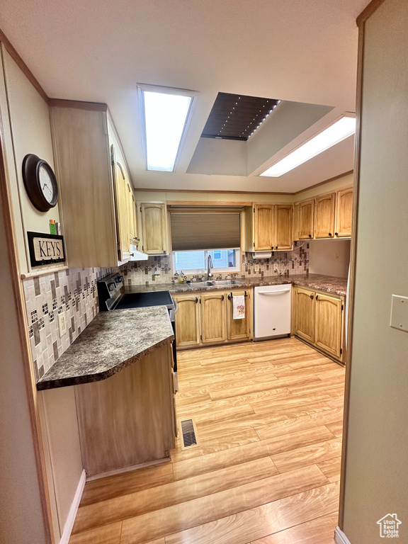 Kitchen with light hardwood / wood-style flooring, tasteful backsplash, dishwasher, range with electric cooktop, and sink