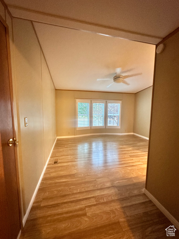 Spare room with a textured ceiling, ceiling fan, and hardwood / wood-style floors