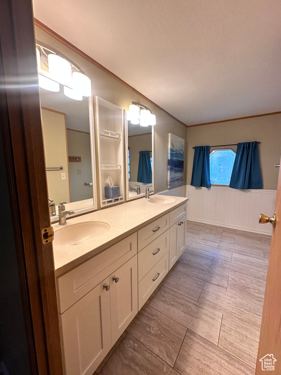 Bathroom with dual vanity and a textured ceiling