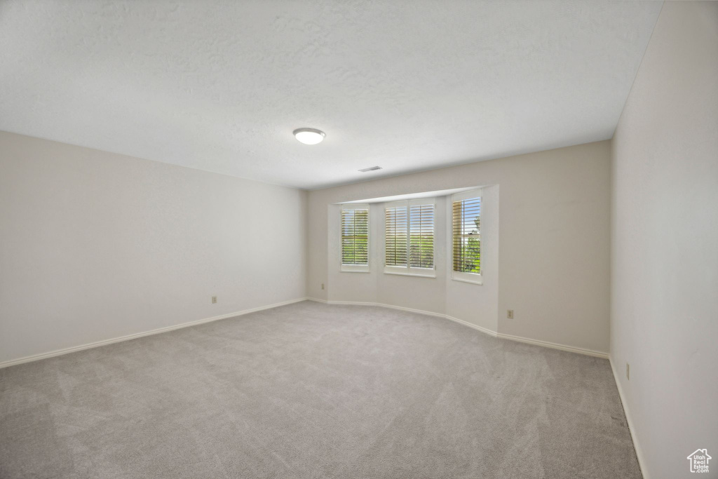 Unfurnished room featuring carpet floors