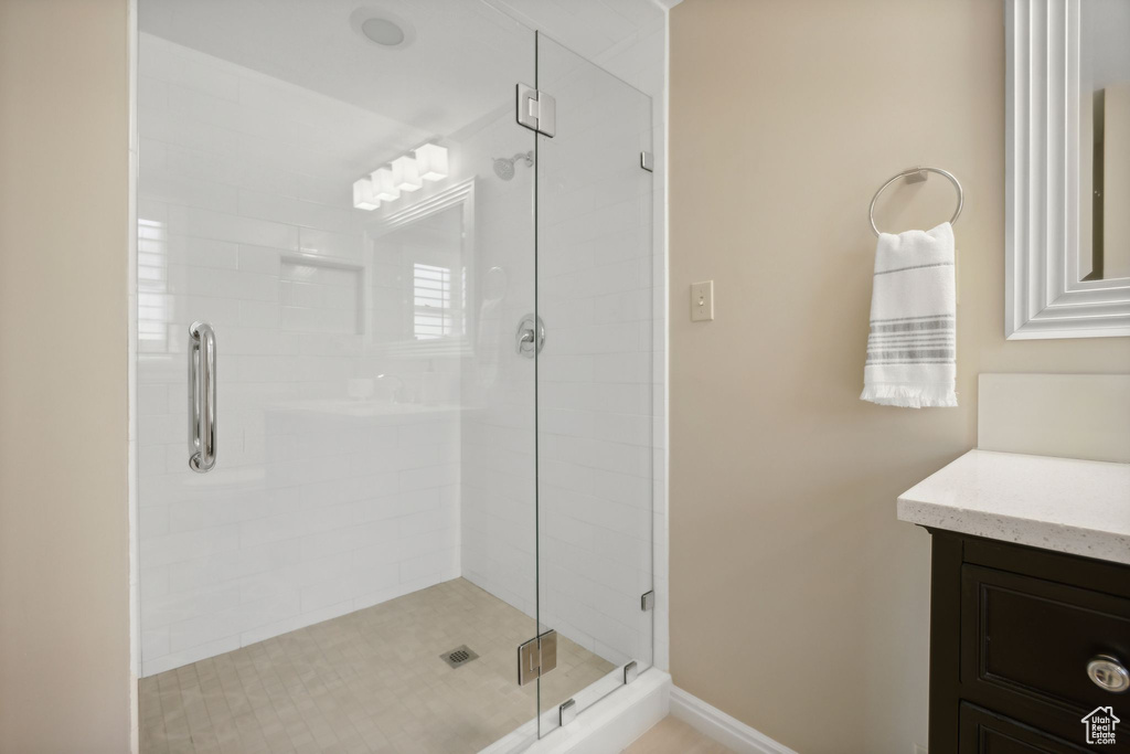 Bathroom with a shower with door and vanity