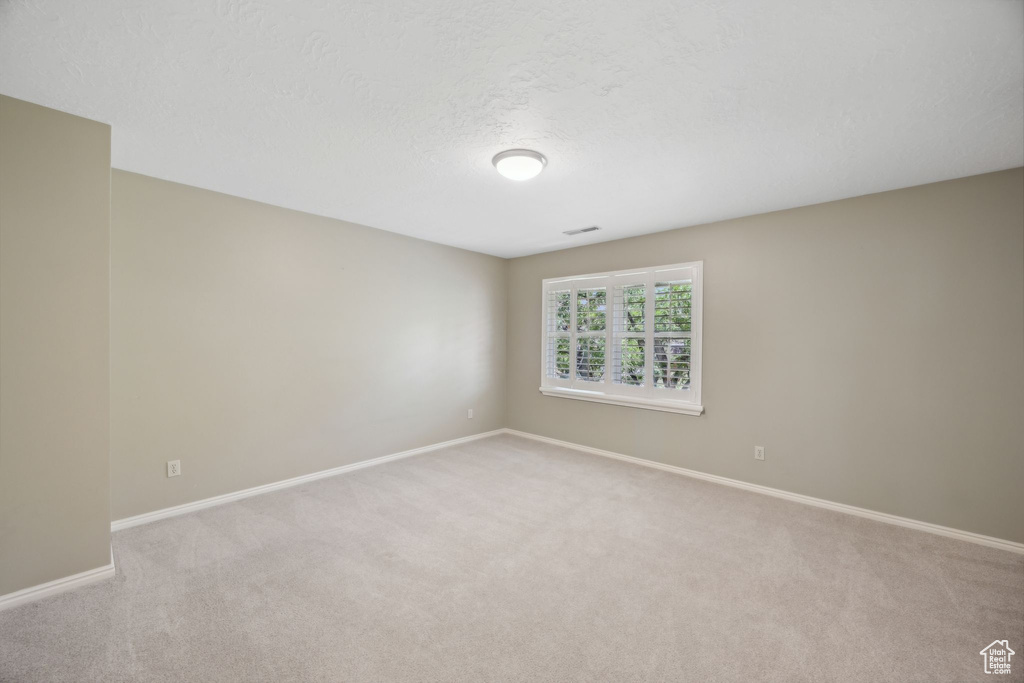 Empty room with carpet floors