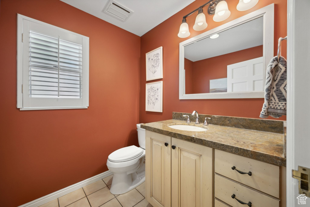 Bathroom with vanity, tile patterned floors, and toilet